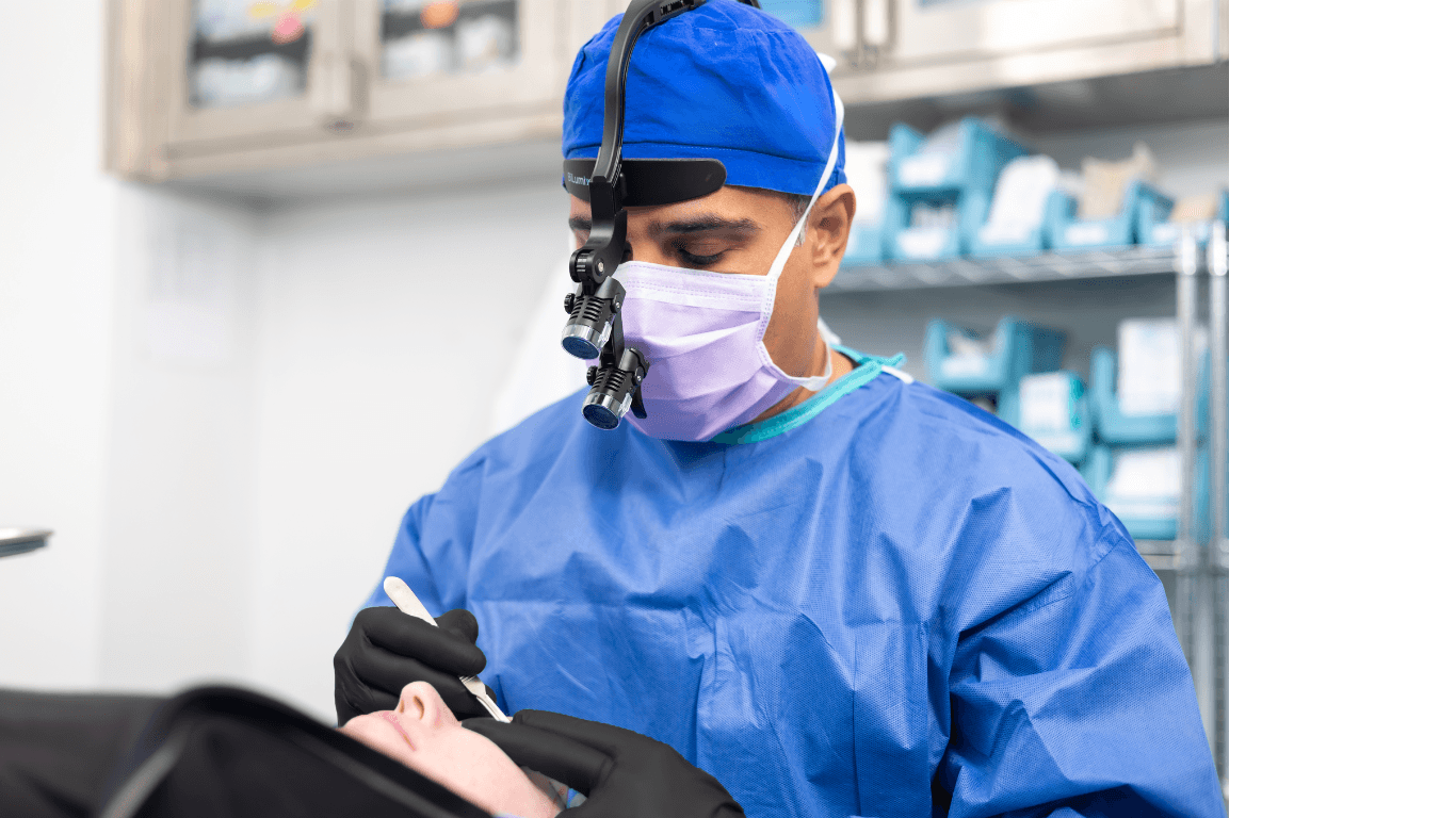 oculoplastic surgeon examining patient periocular region with loupes